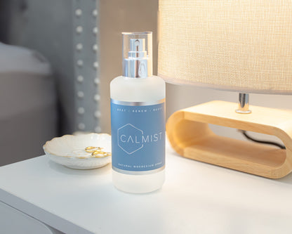 Bottle of 'CALMIST' on a nightstand next to a lamp